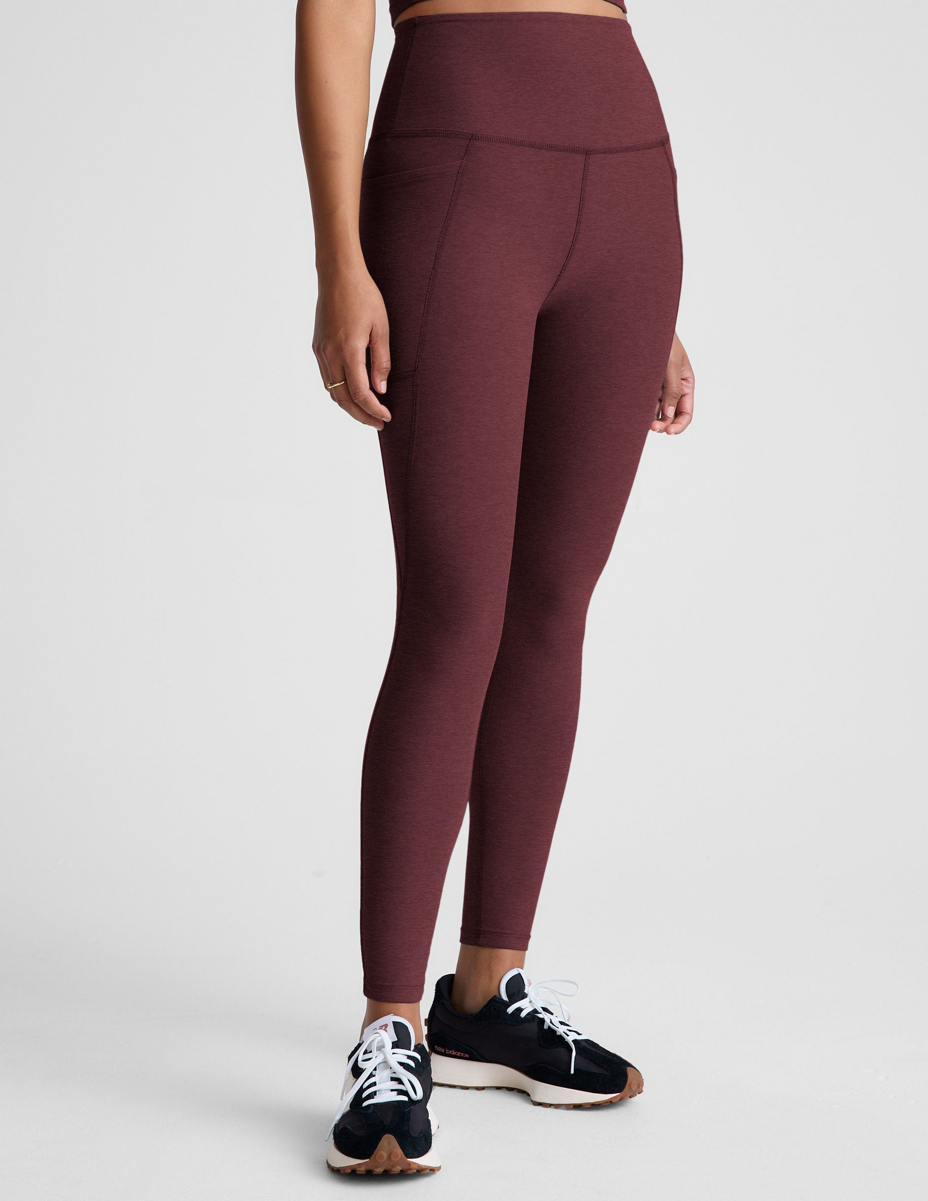 red high-waisted midi length leggings with pockets.