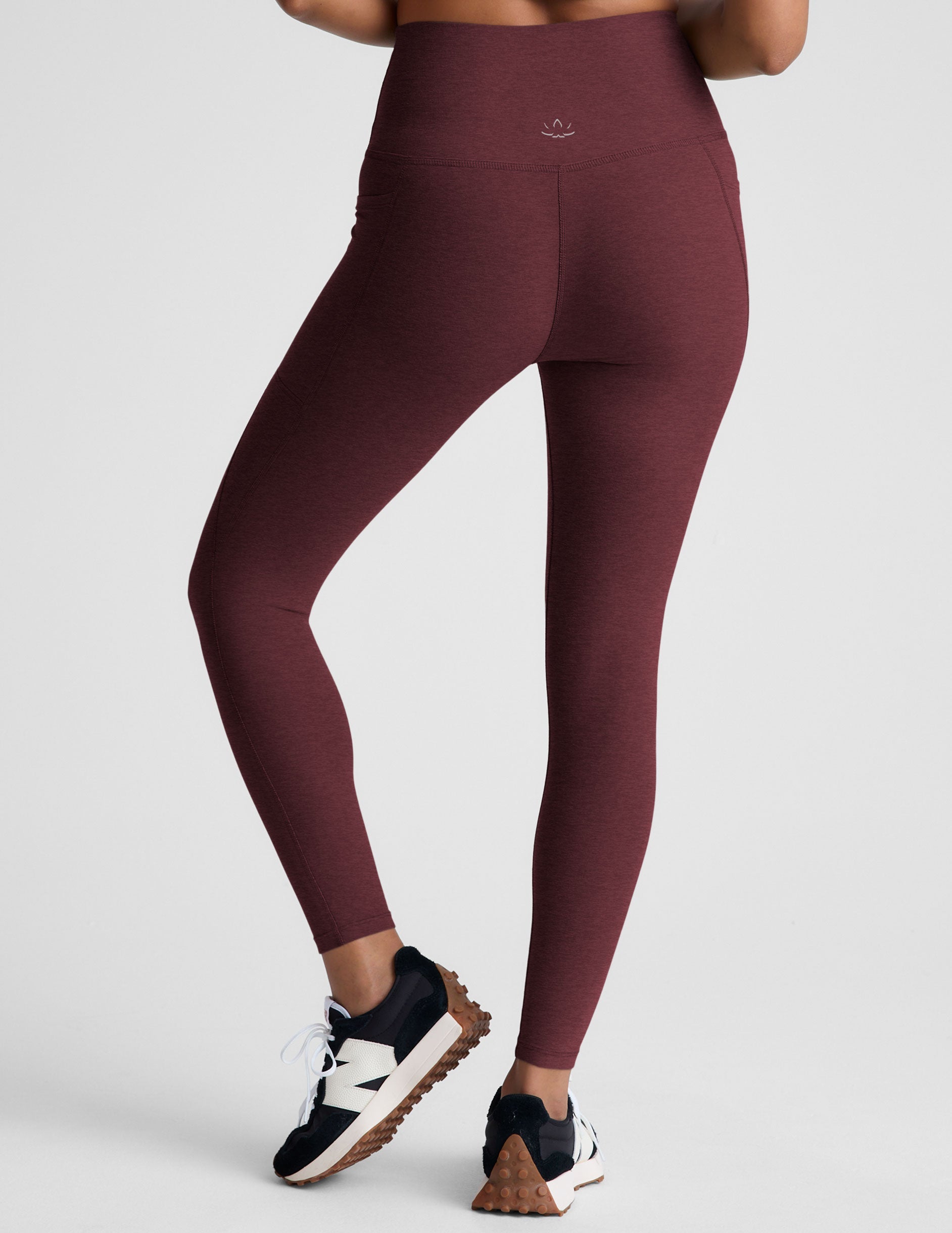 red high-waisted midi length leggings with pockets.