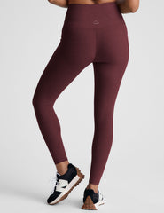 red high-waisted midi length leggings with pockets.