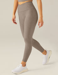 brown high-waisted midi leggings with a front crossover waistband.