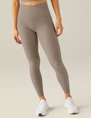 brown high-waisted midi leggings with a front crossover waistband.