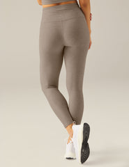brown high-waisted midi leggings with a front crossover waistband.
