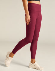 red high-waisted midi leggings with a crossover detail on the front waistband.