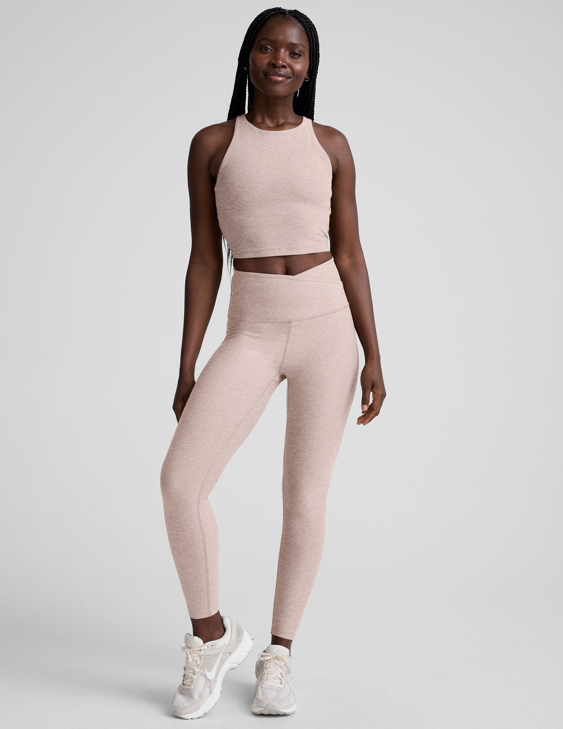 Woman wearing a chai athletic outfit on a white background