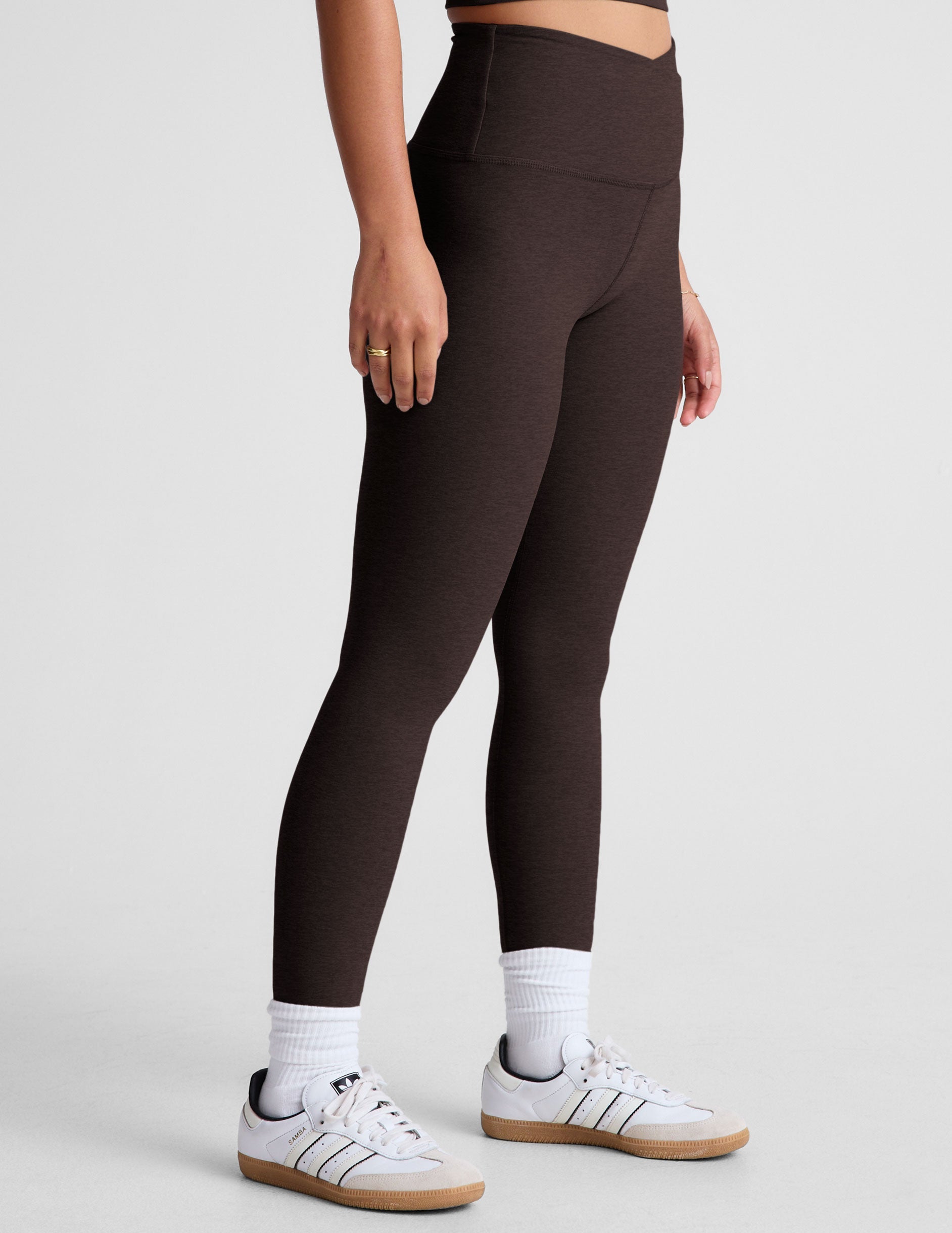 brown high-waisted midi length leggings with an overlapping front waistband.