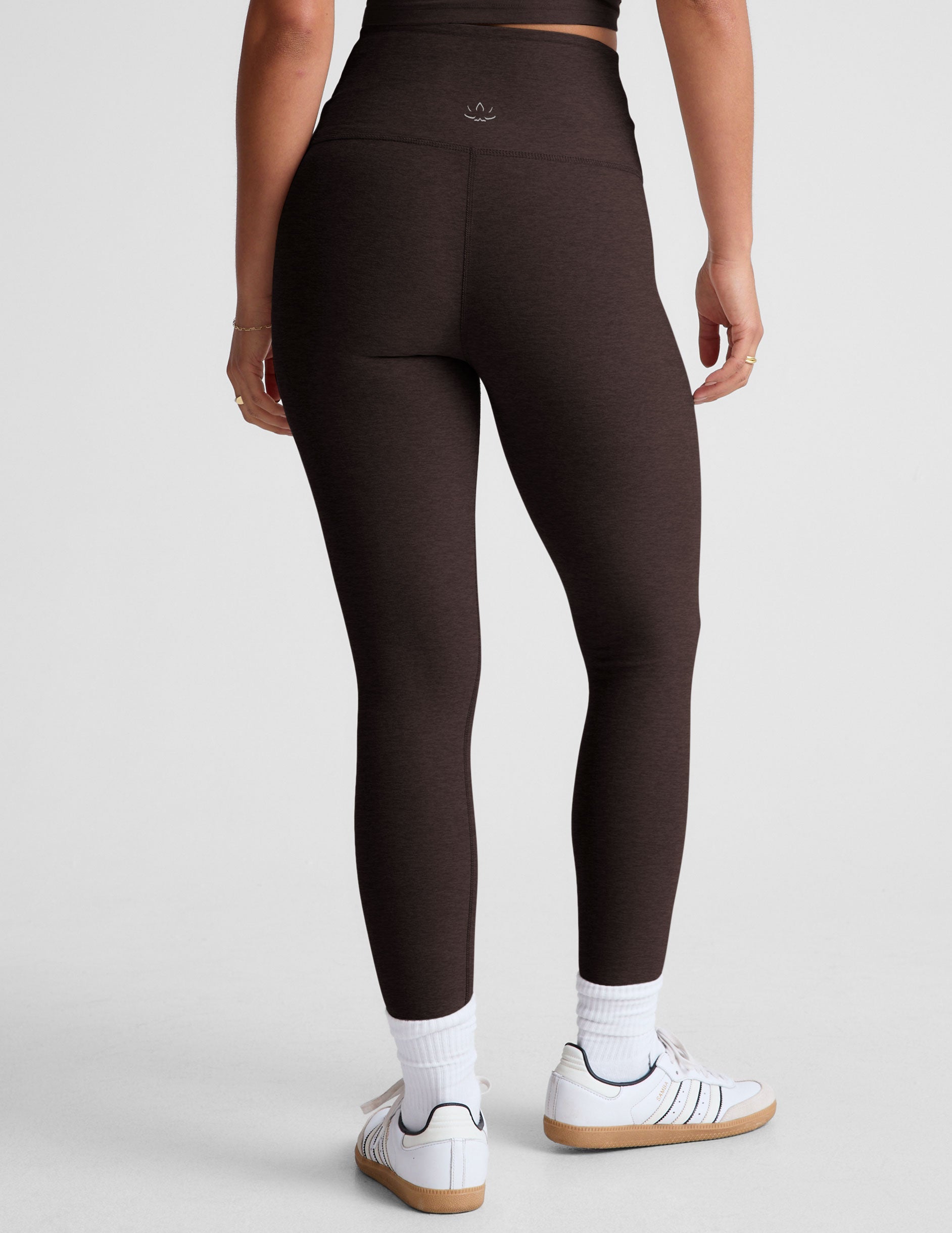 brown high-waisted midi length leggings with an overlapping front waistband.