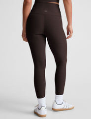 brown high-waisted midi length leggings with an overlapping front waistband.
