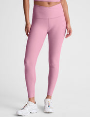 pink high-waisted midi leggings with a crossover detail on the front waistband.