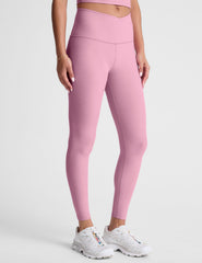 pink high-waisted midi leggings with a crossover detail on the front waistband.