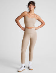 brown high-waisted midi length leggings with a crossover detail on the front waistband.