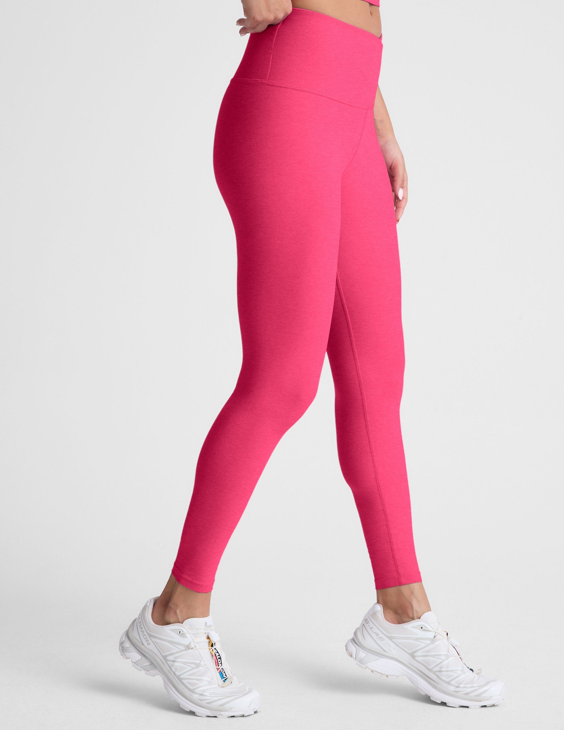 pink high-waisted midi length leggings with a crossover detail on the front waistband.