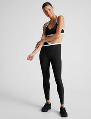 black high-waisted midi length legging with white contrast binding at crossover waistband.