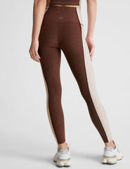 brown high-waisted midi leggings with white lining on the sides.