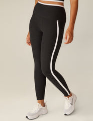 black pocket high-waisted midi legging with white lining around waistband and down the sides.