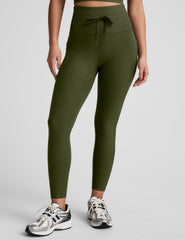 green high-waisted midi length leggings with pockets and a drawstring at waistband.