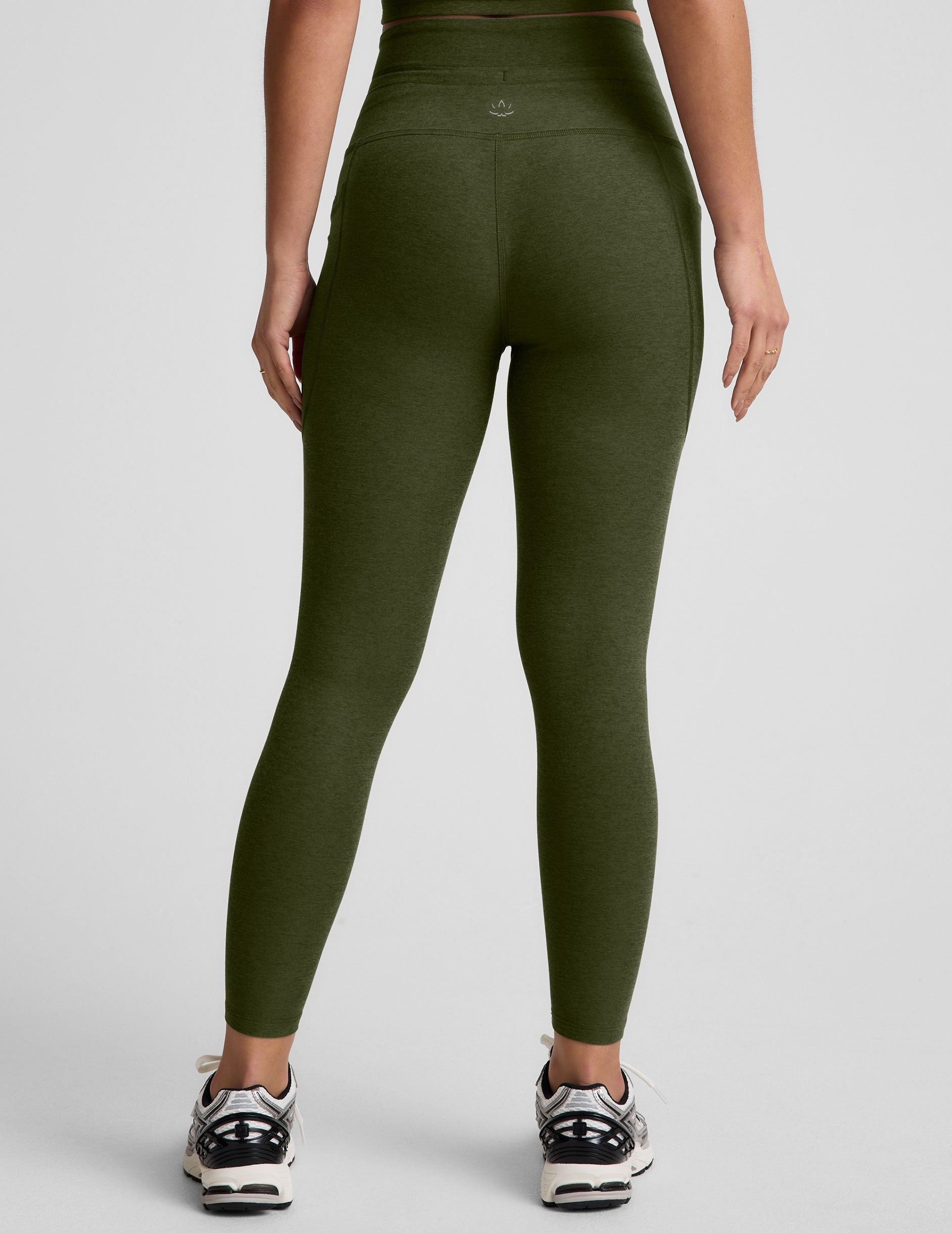 green high-waisted midi length leggings with pockets and a drawstring at waistband.