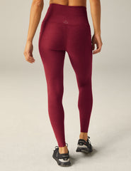 red waisted midi leggings with a drawstring at the waistband and side pockets.