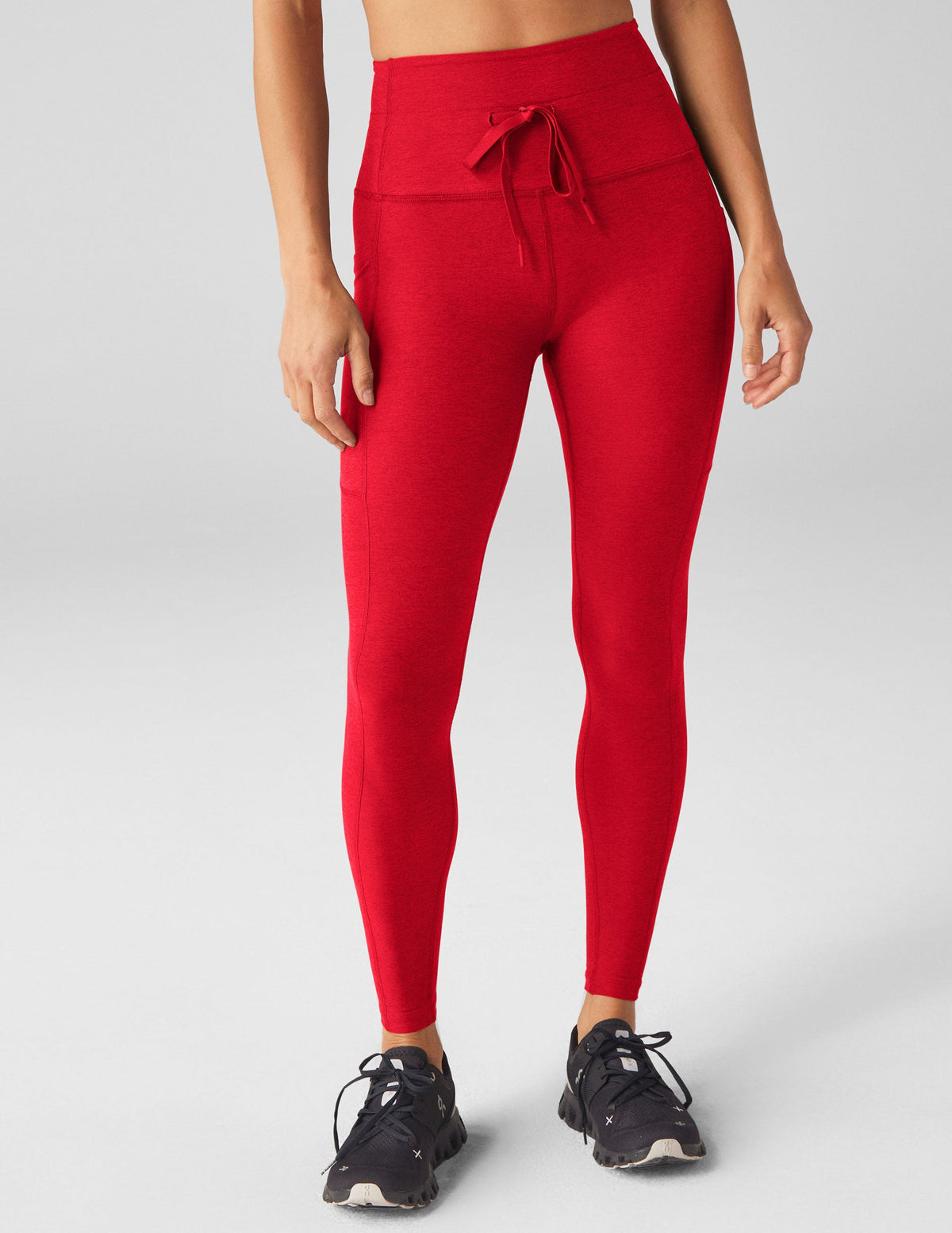 red high-waisted midi leggings with a drawstring at waistband.