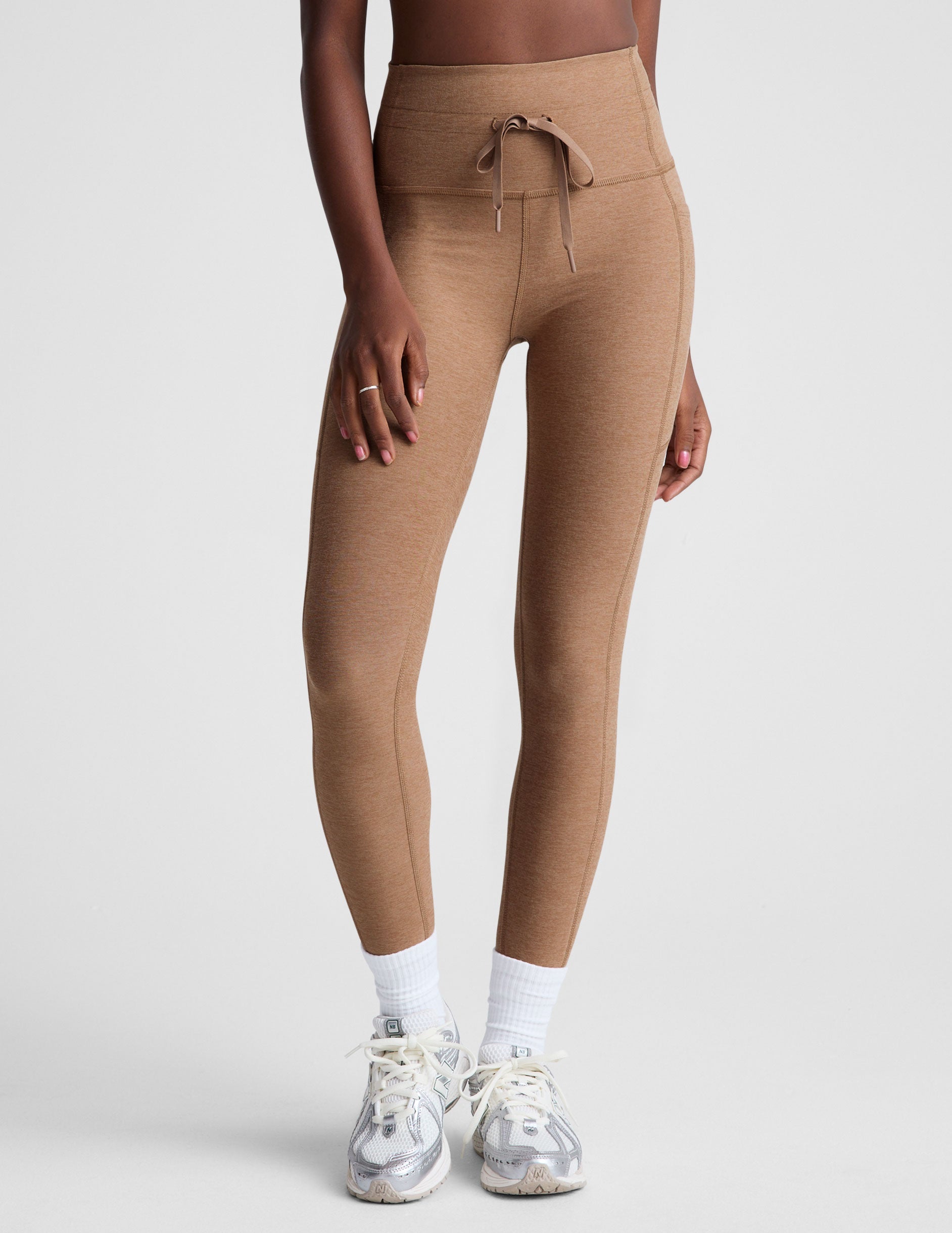 brown high-waisted midi leggings with a drawstring at waistband.
