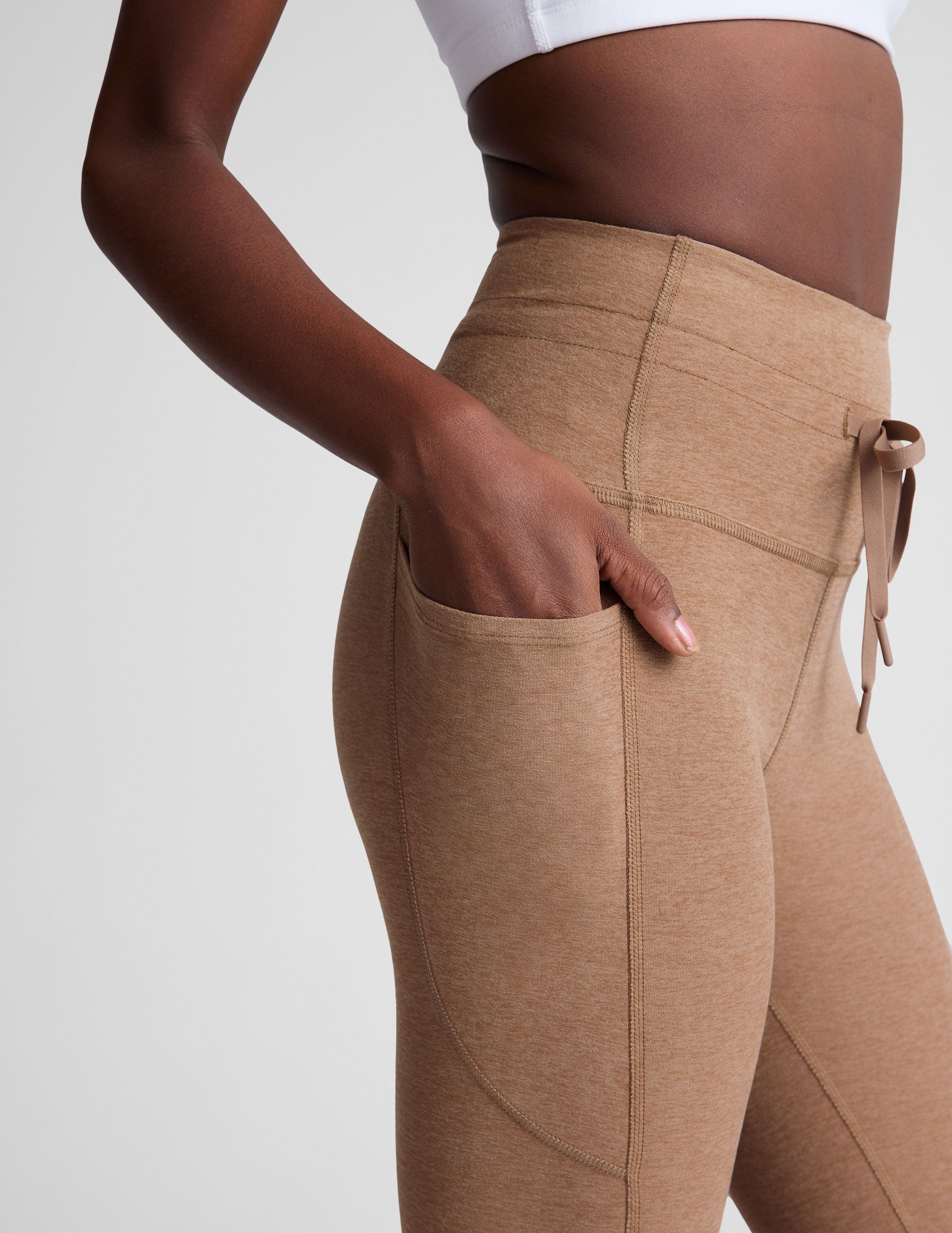 brown high-waisted midi leggings with a drawstring at waistband.