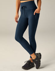 blue high-waisted midi leggings with a drawstring at waistband and side pockets.