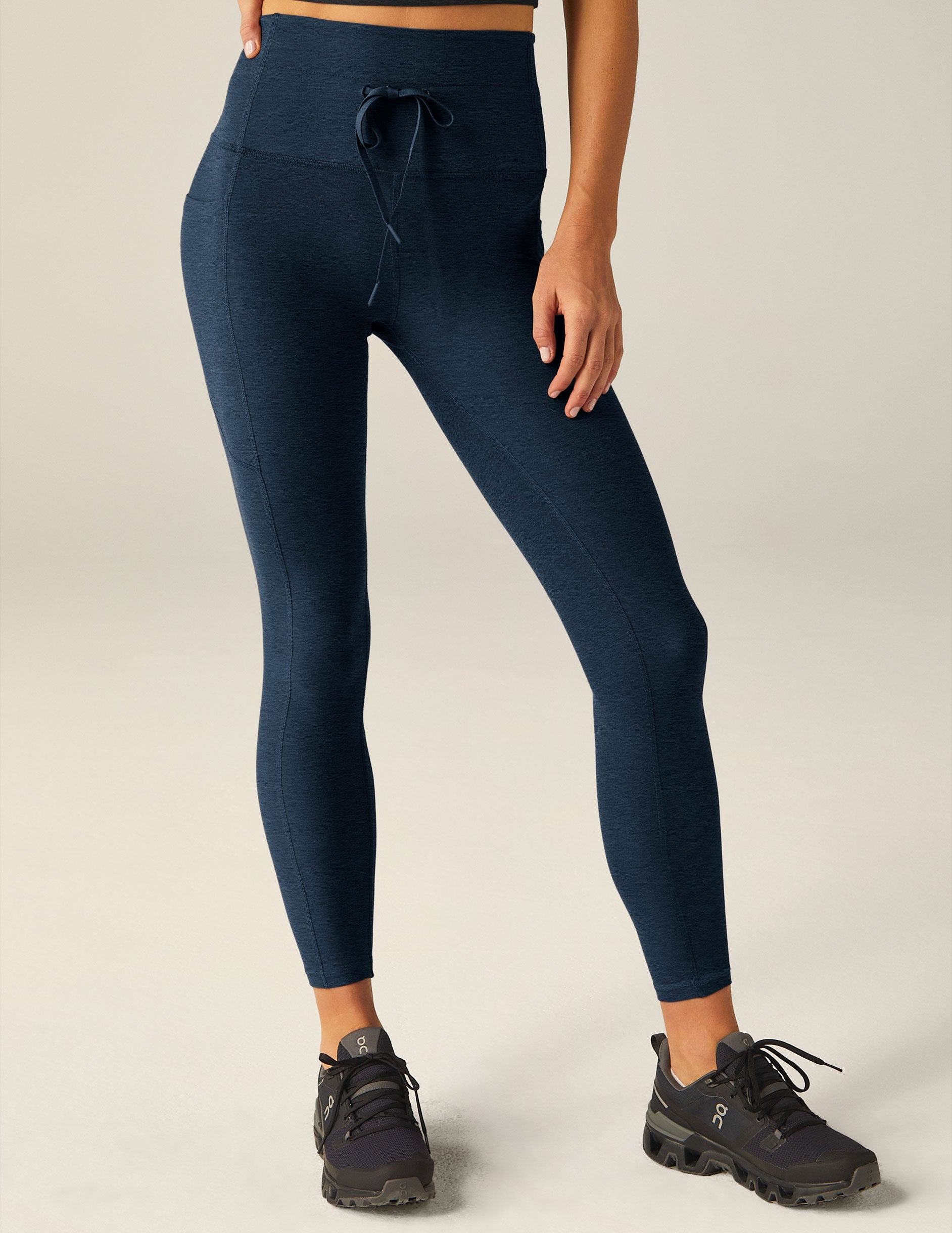 blue high-waisted midi leggings with a drawstring at waistband and side pockets.