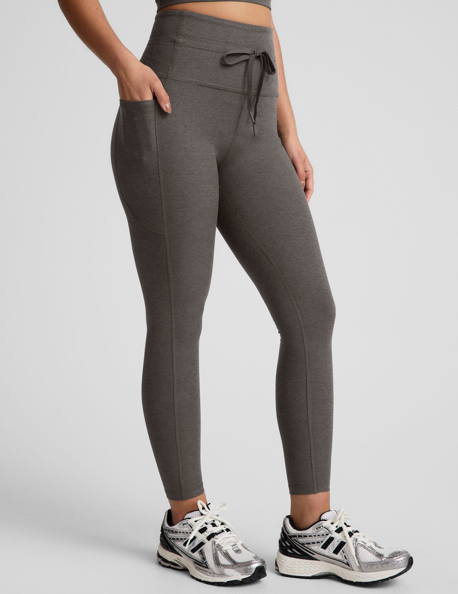 gray high-waisted midi length leggings with a drawstring at waistband and side pockets.