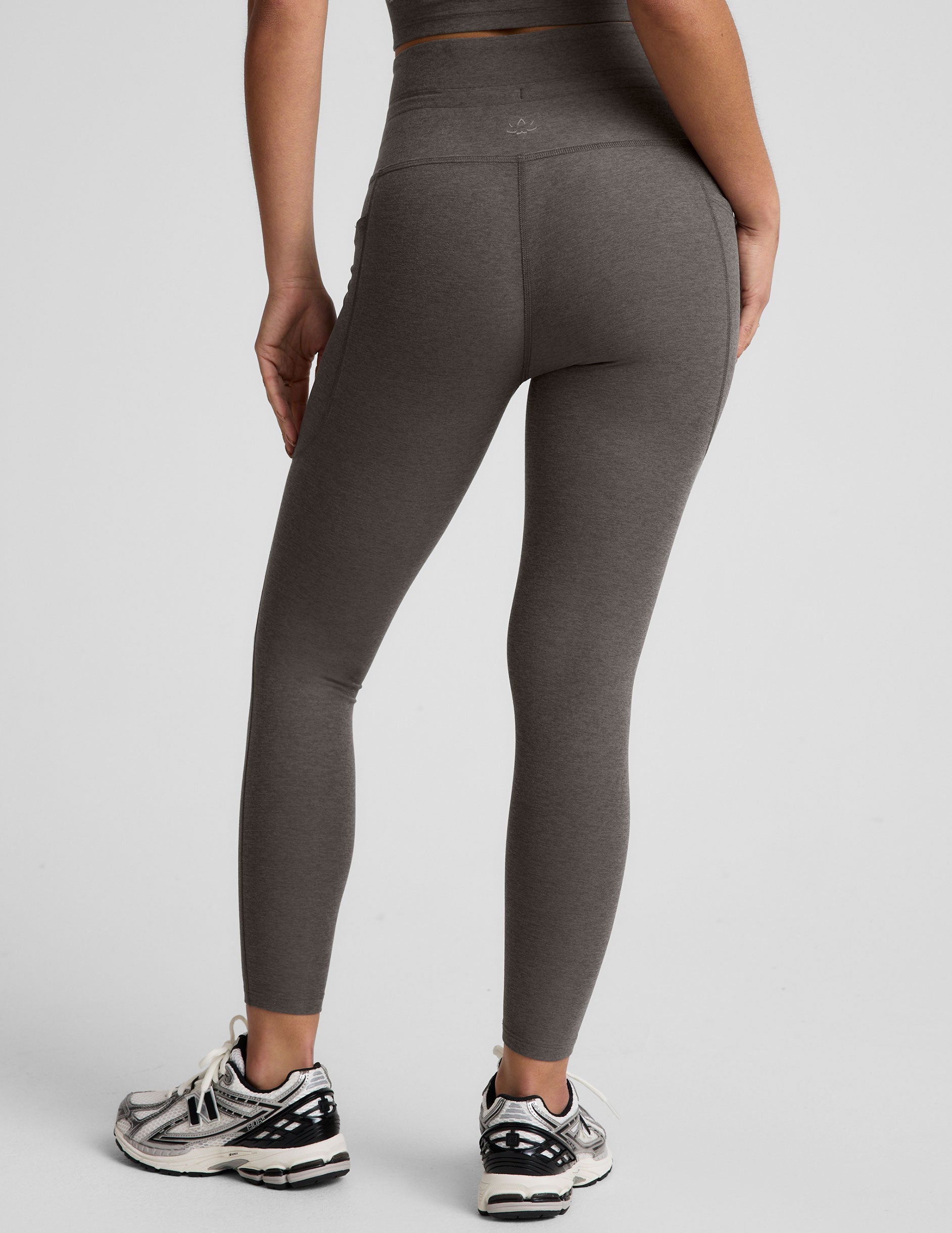 gray high-waisted midi length leggings with a drawstring at waistband and side pockets.