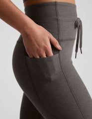 gray high-waisted midi length leggings with a drawstring at waistband and side pockets.