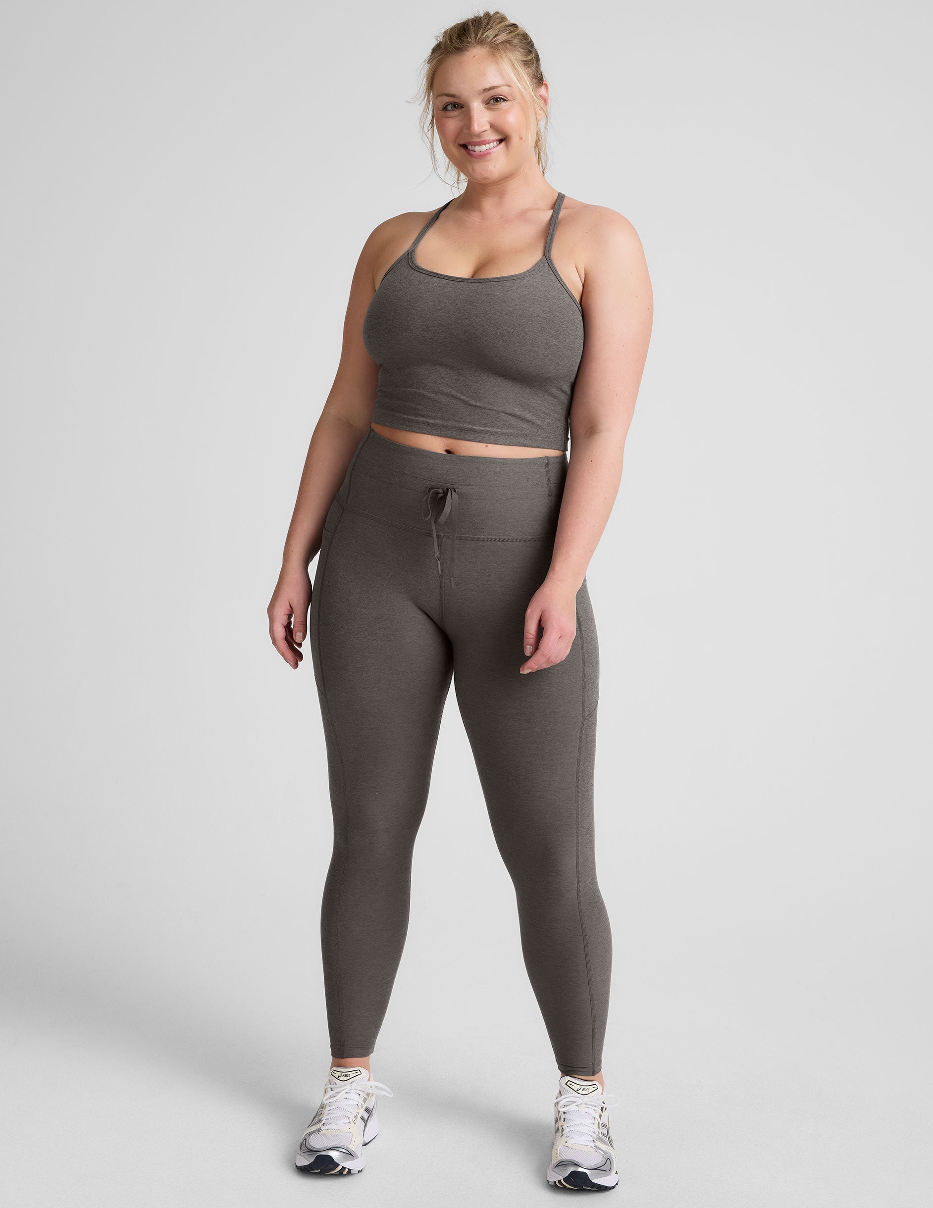 gray high-waisted midi length leggings with a drawstring at waistband and side pockets.