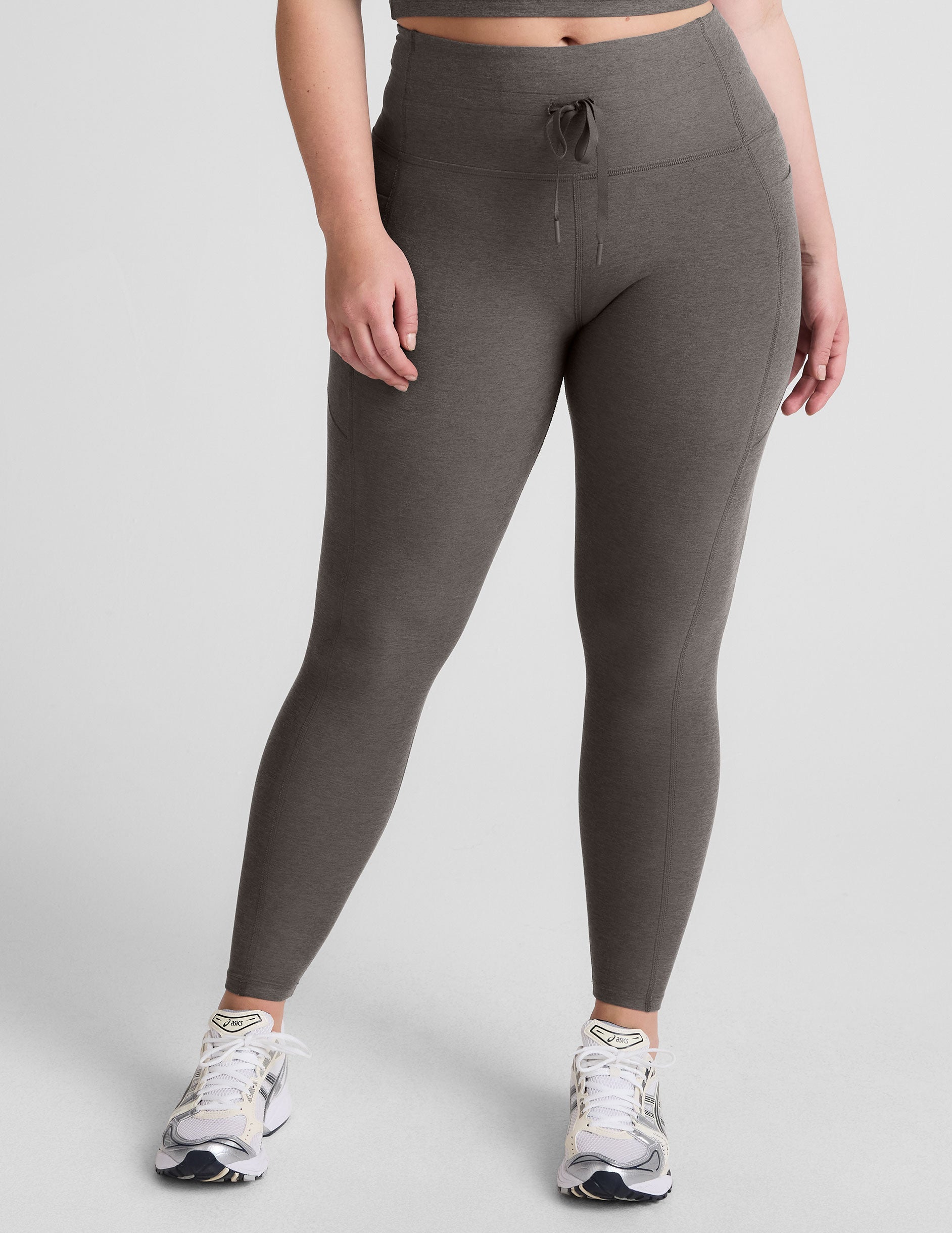 gray high-waisted midi length leggings with a drawstring at waistband and side pockets.