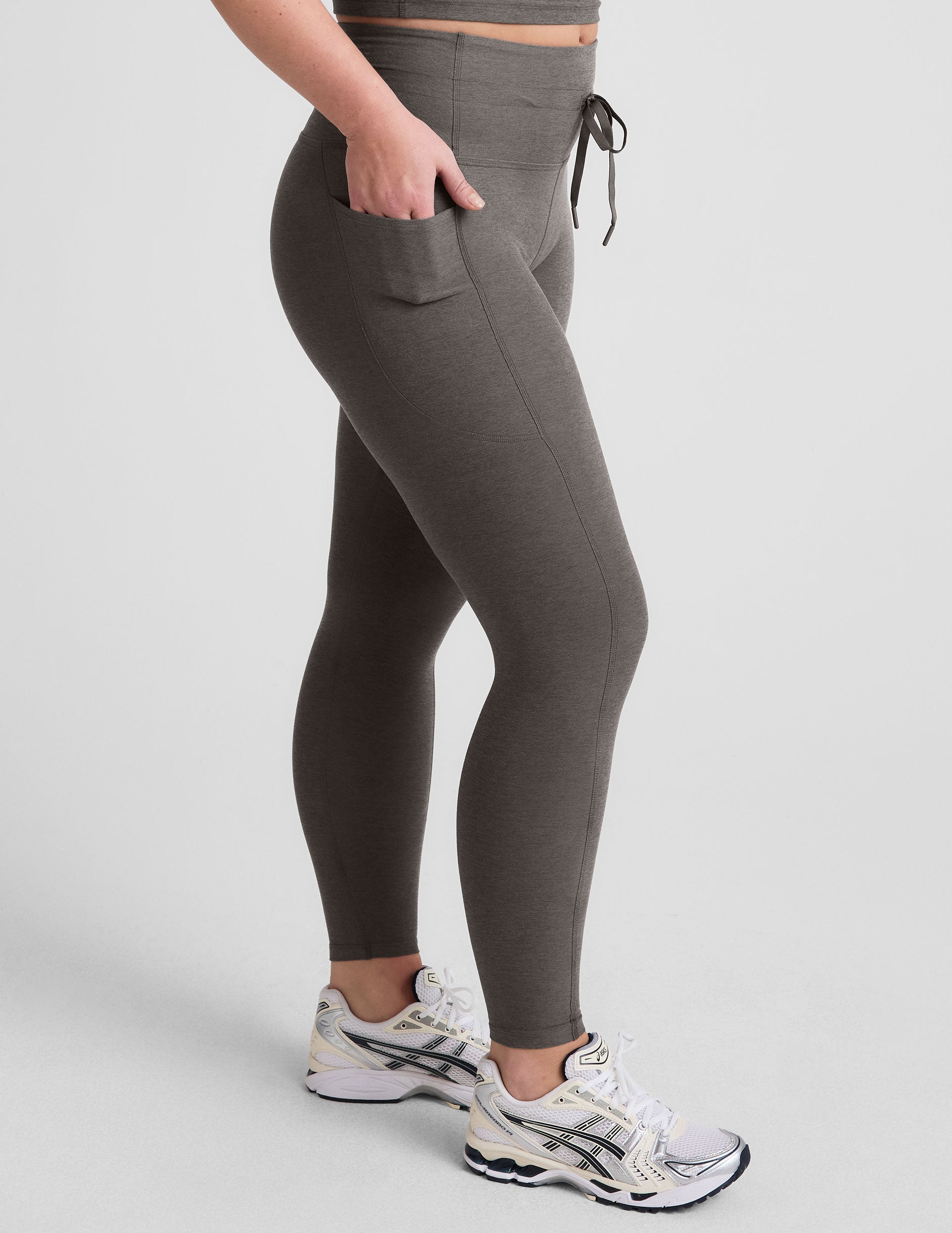 gray high-waisted midi length leggings with a drawstring at waistband and side pockets.