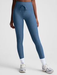 blue high-waisted midi leggings with pockets and a drawstring at waistband.