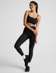 black high-waisted midi length legging with a shirred detail on the sides of the waistband.
