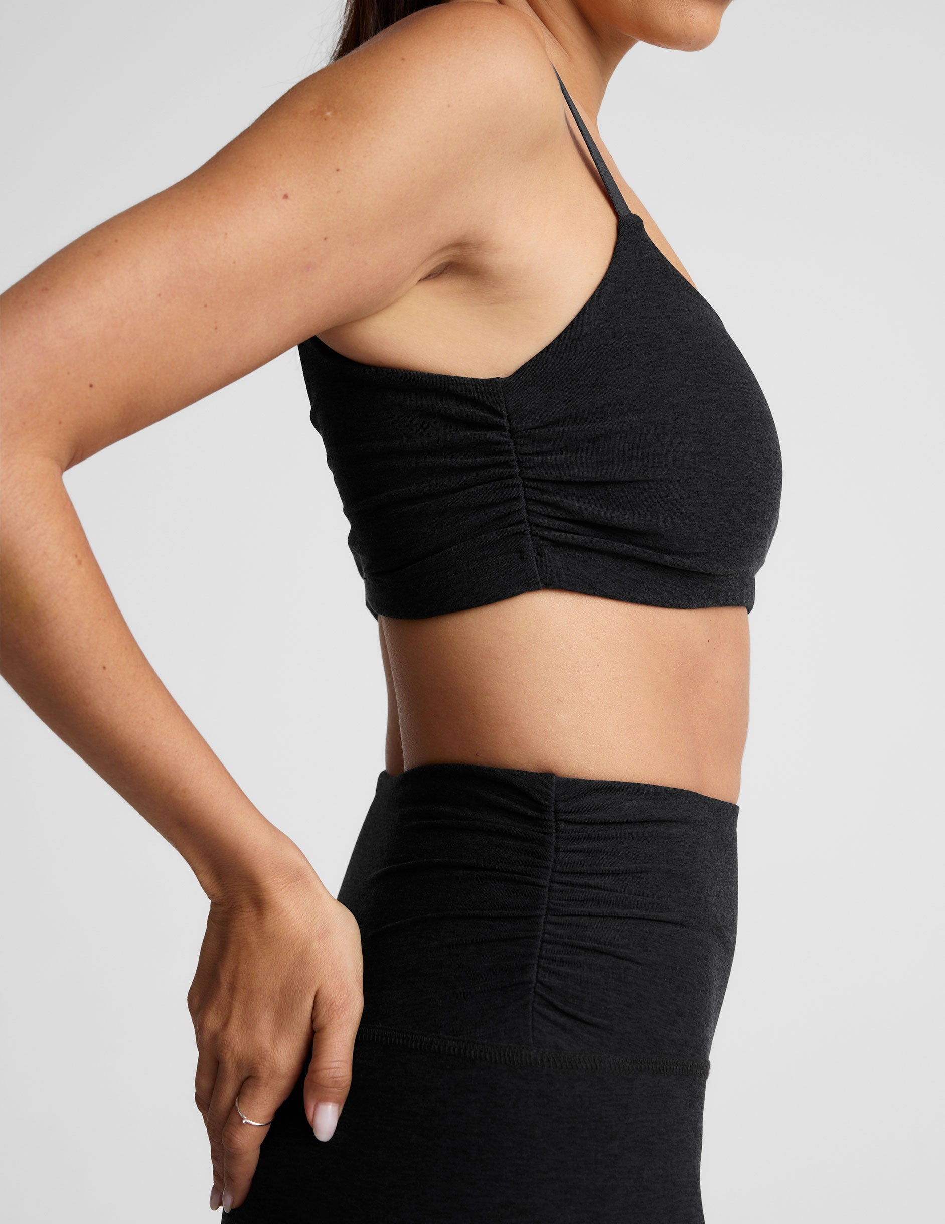 black high-waisted midi length legging with a shirred detail on the sides of the waistband.