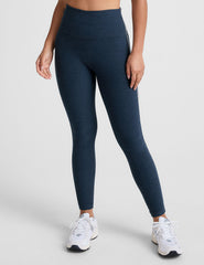 blue high-waisted midi length leggings with white piping on the side.
