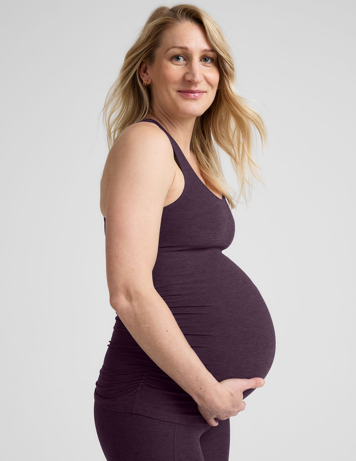 purple maternity racerback tank top and purple maternity midi length leggings.