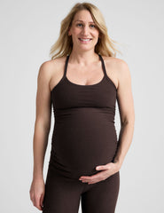 model wearing a brown maternity racerback tank top against a plain background.
