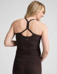 model wearing a brown maternity racerback tank top against a plain background.