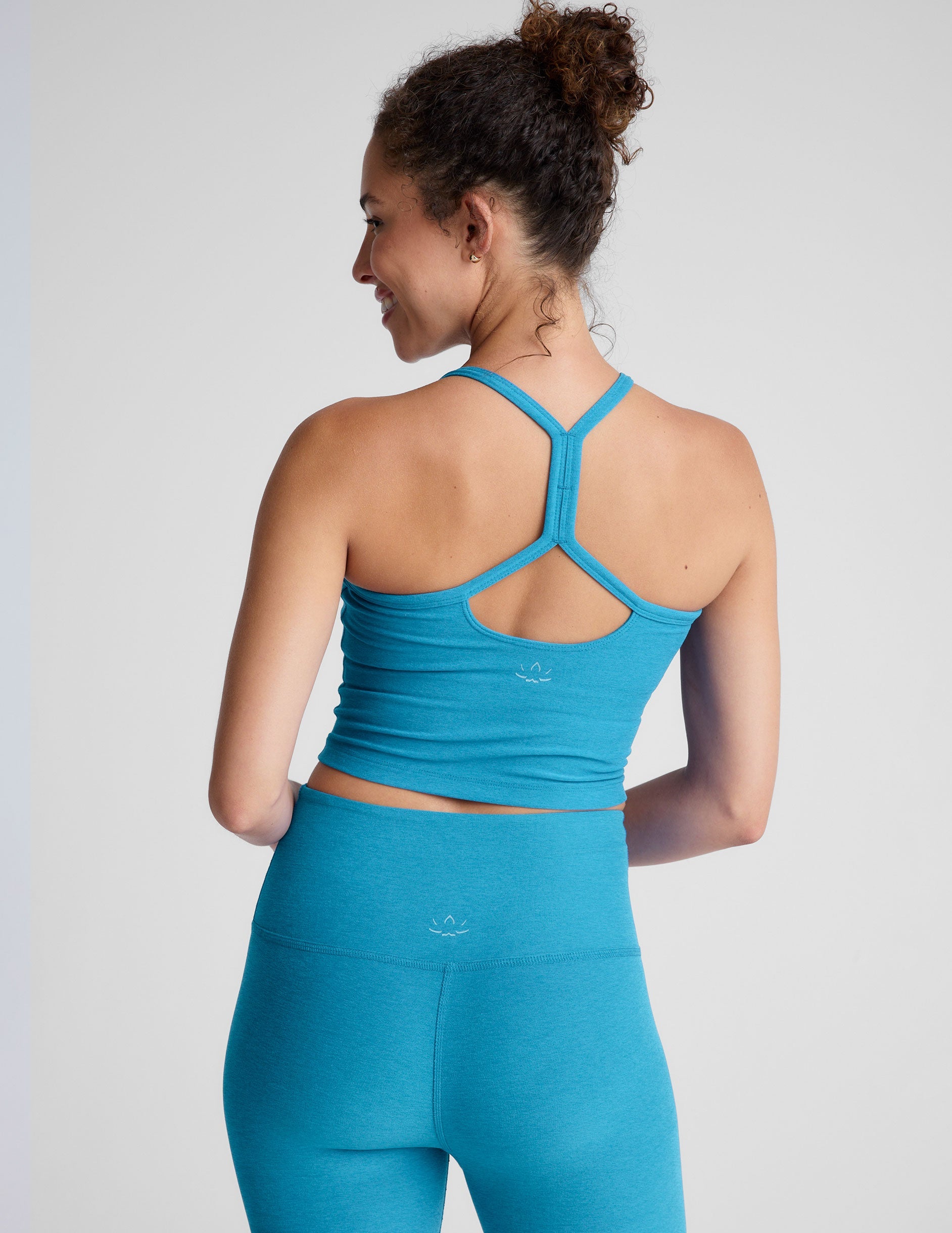 blue racerback cropped tank top with spaghetti straps.