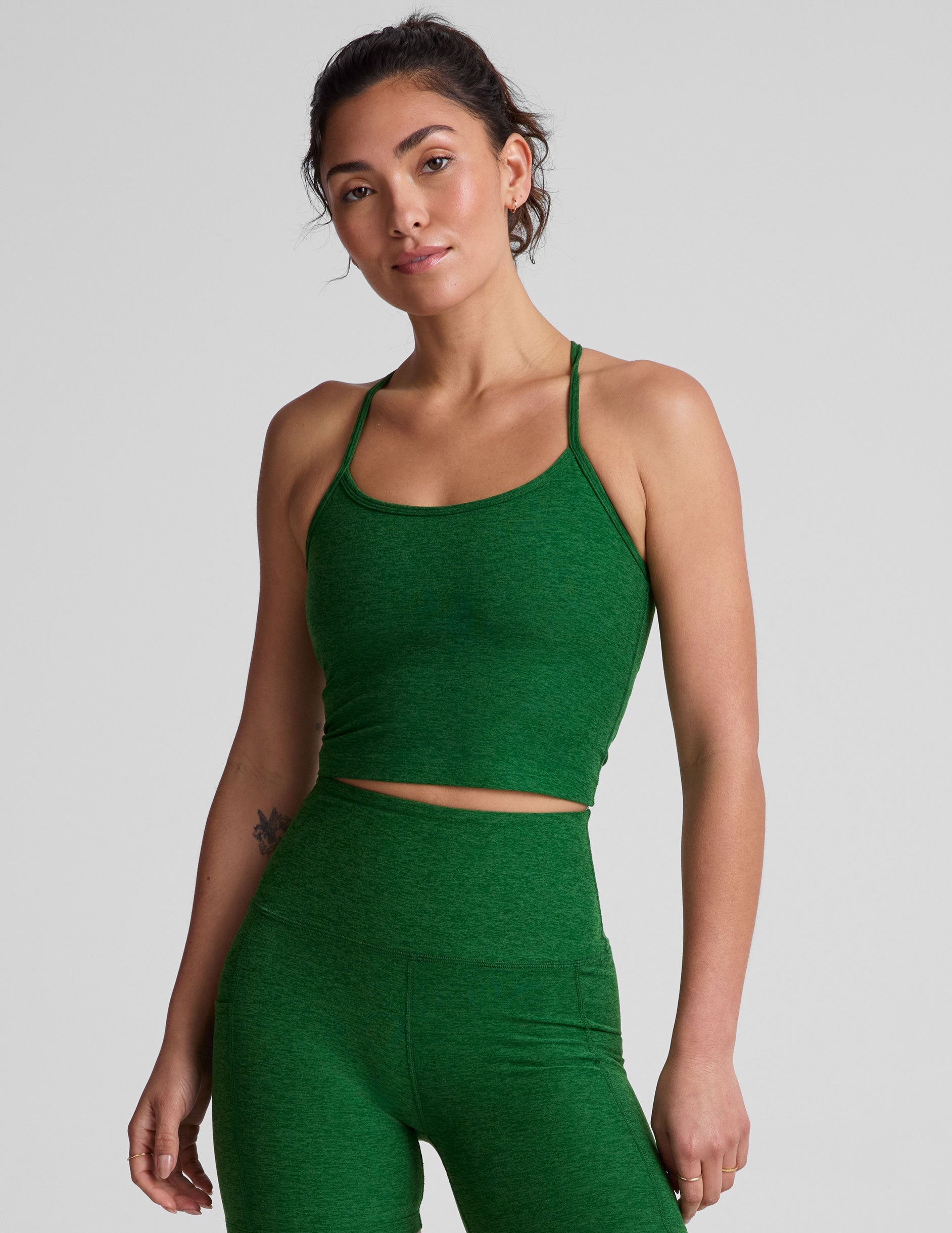green racerback cropped tank top with slim spaghetti straps.