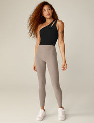 black one-shoulder cropped tank with a cutout on the front strap and a detailing on the back strap.