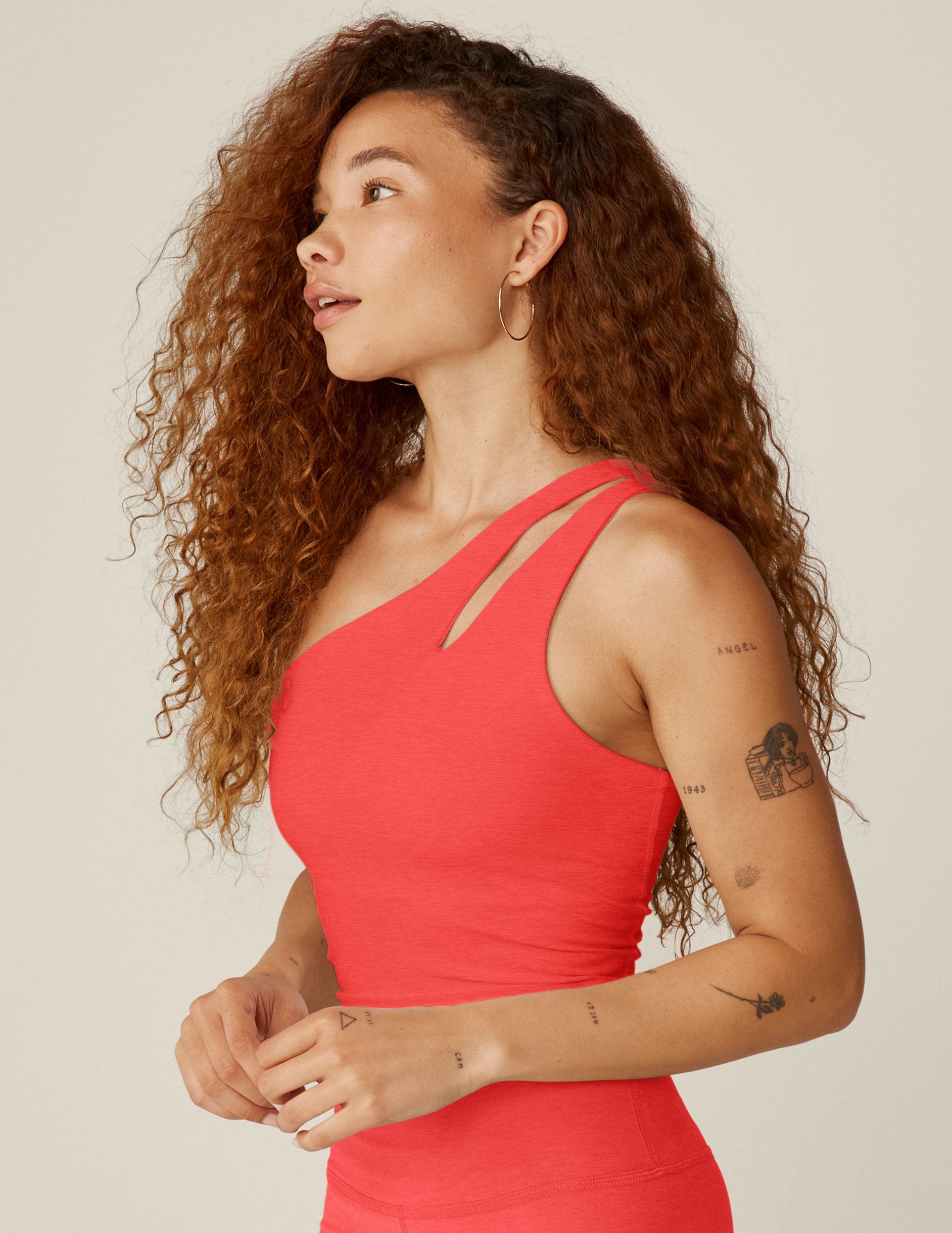 red one-shoulder cropped tank with an cut-out detail on the front strap and a twist detailing on the back strap.