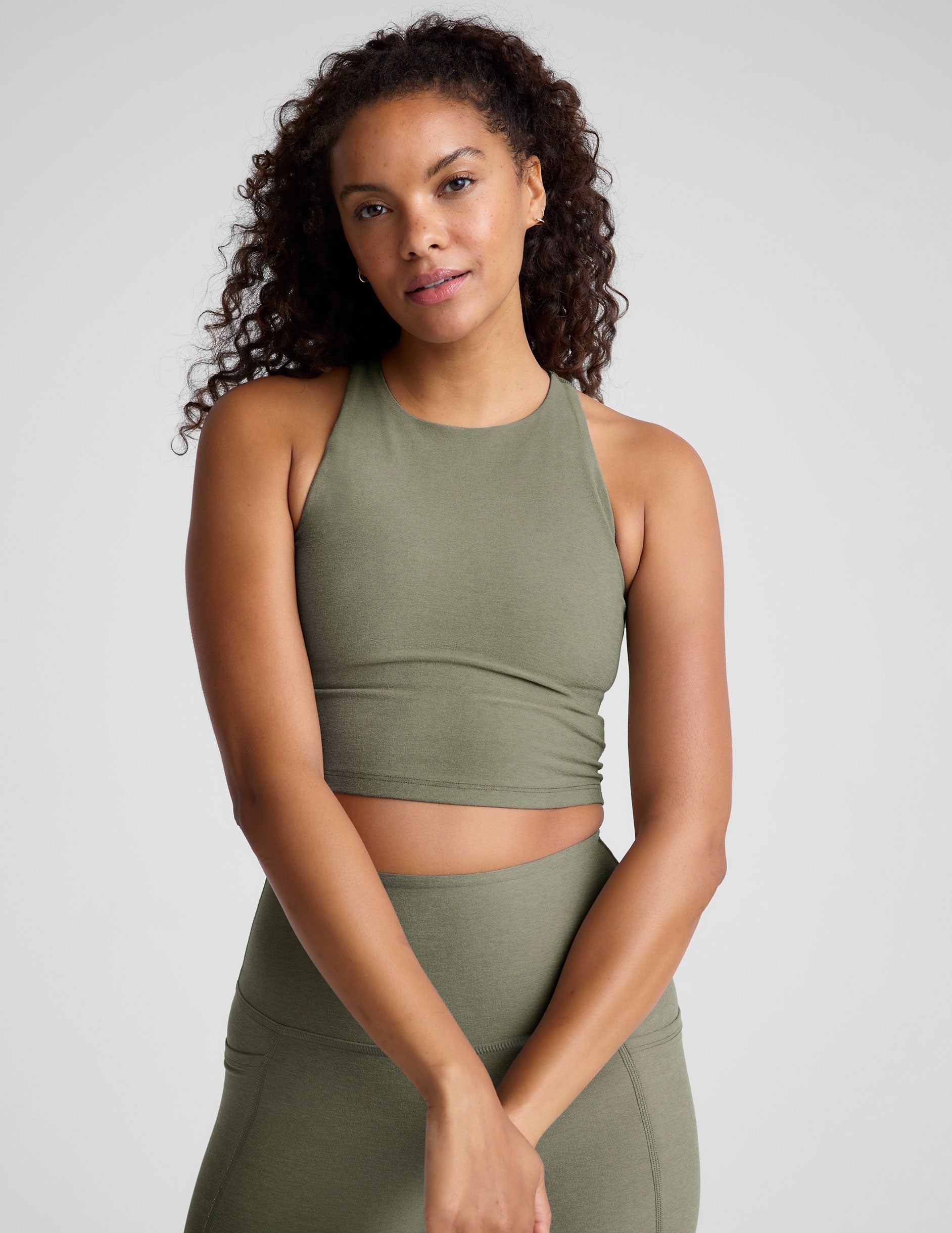 green racerback cropped tank with a high scoop neckline.