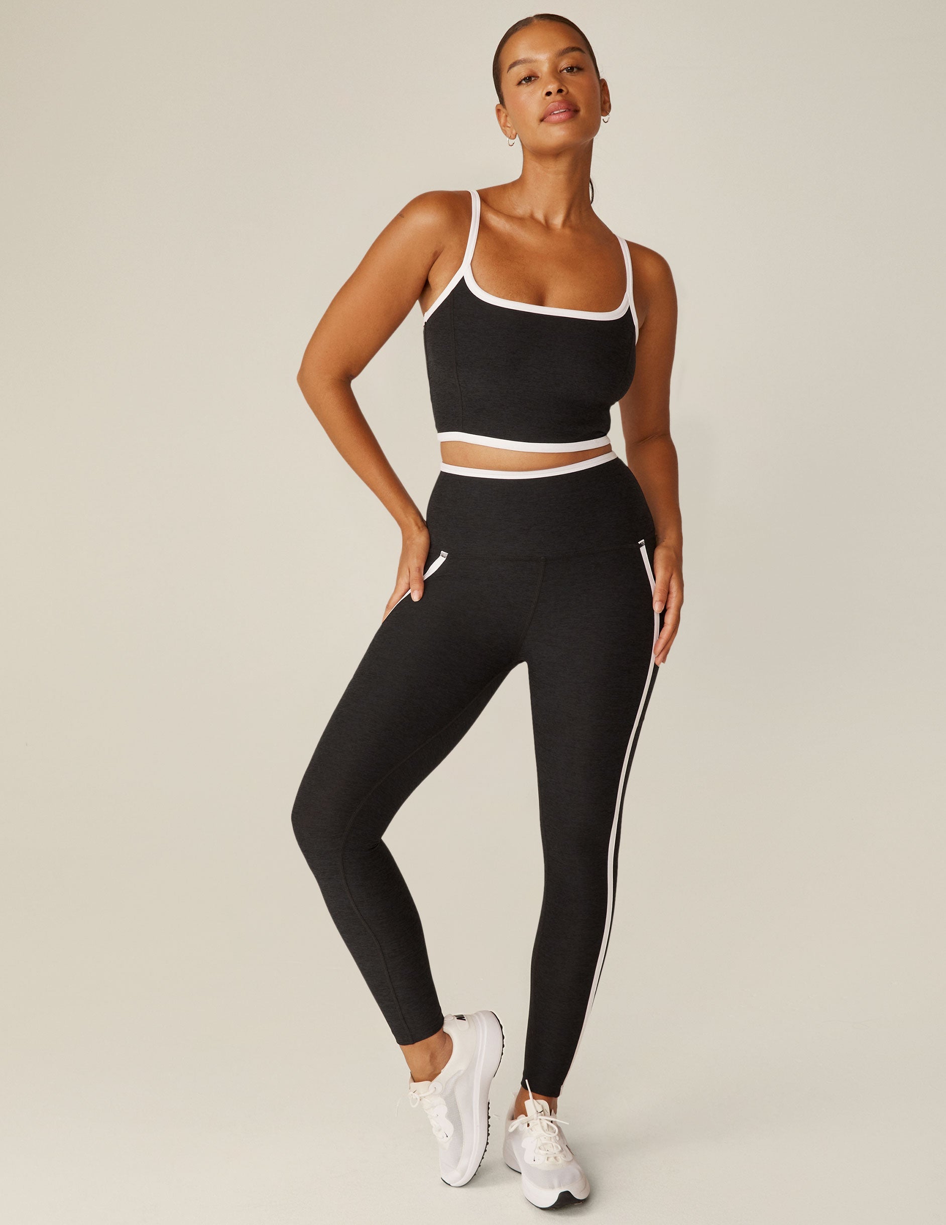 black cropped tank with white lining along neckline and waistline.