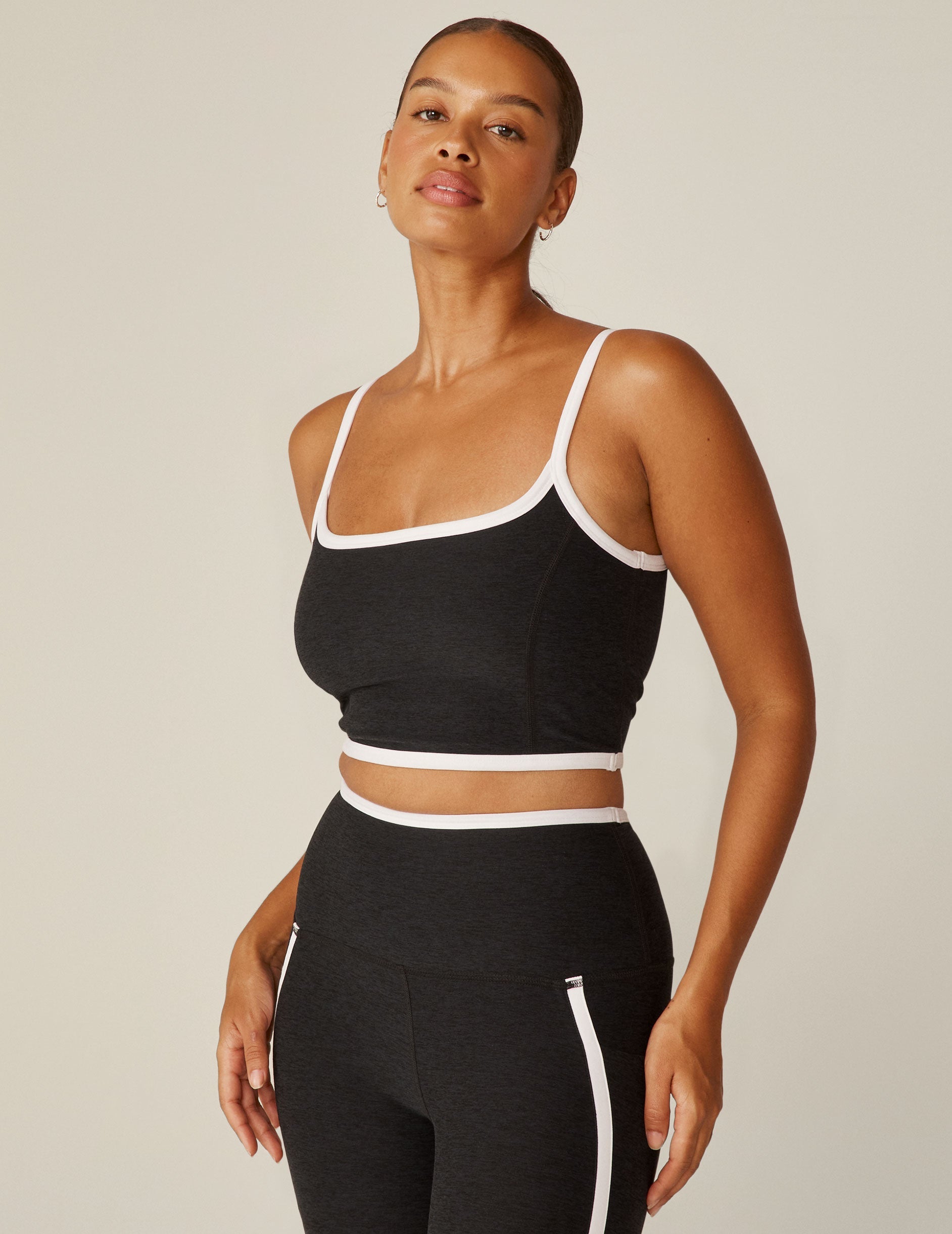 black cropped tank with white lining along neckline and waistline.