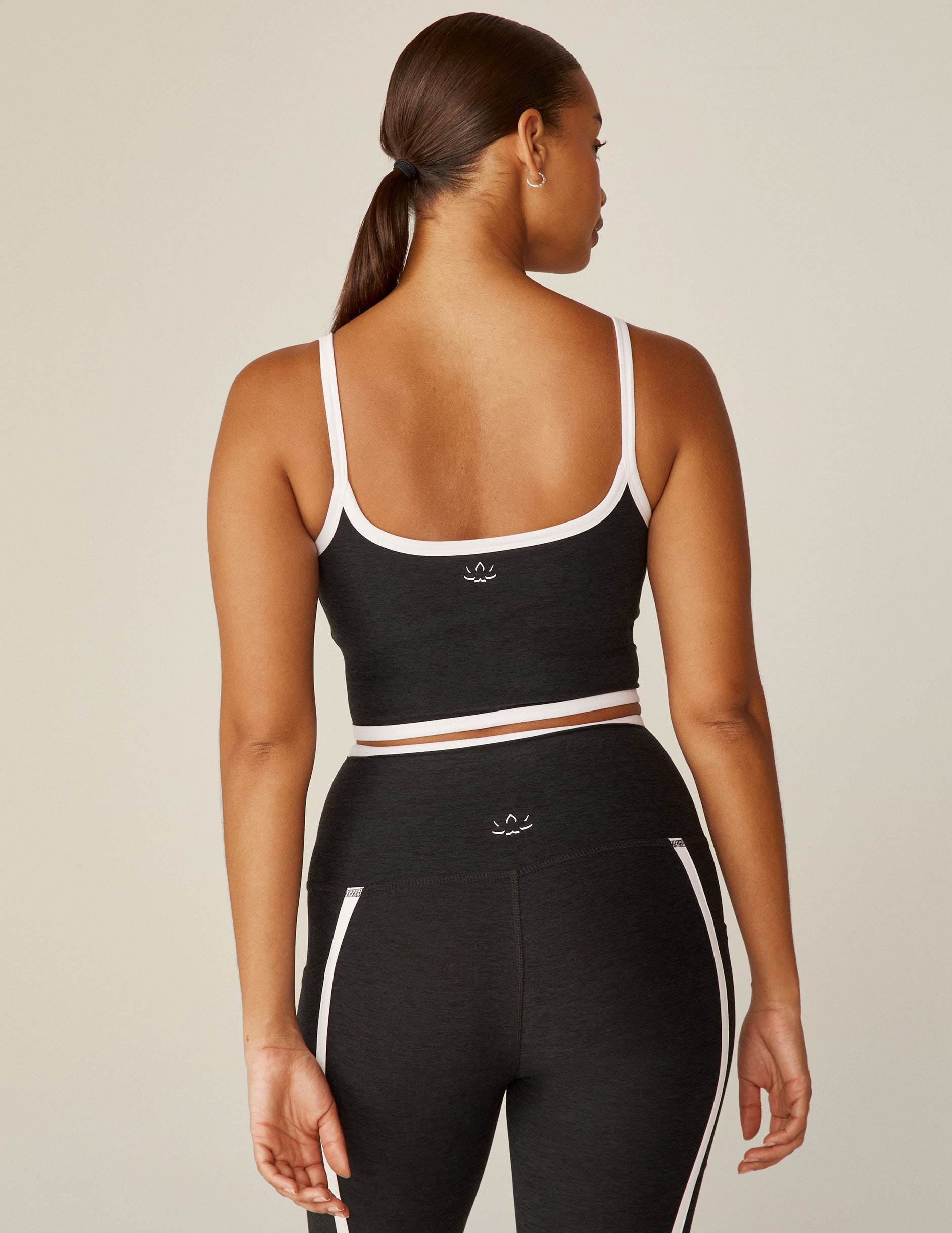 black cropped tank with white lining along neckline and waistline.