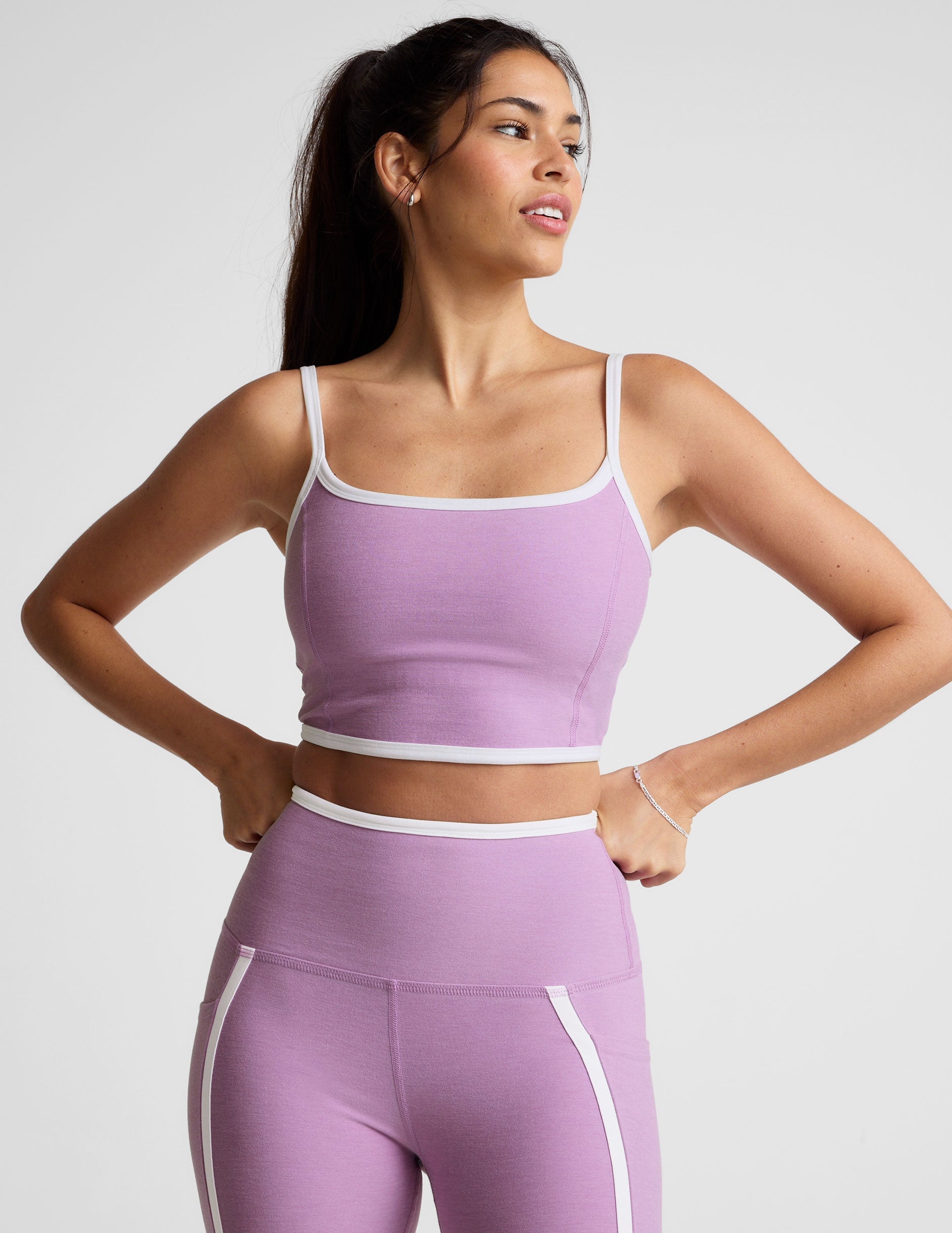 purple cropped tank with princess seams and white piping along edges.