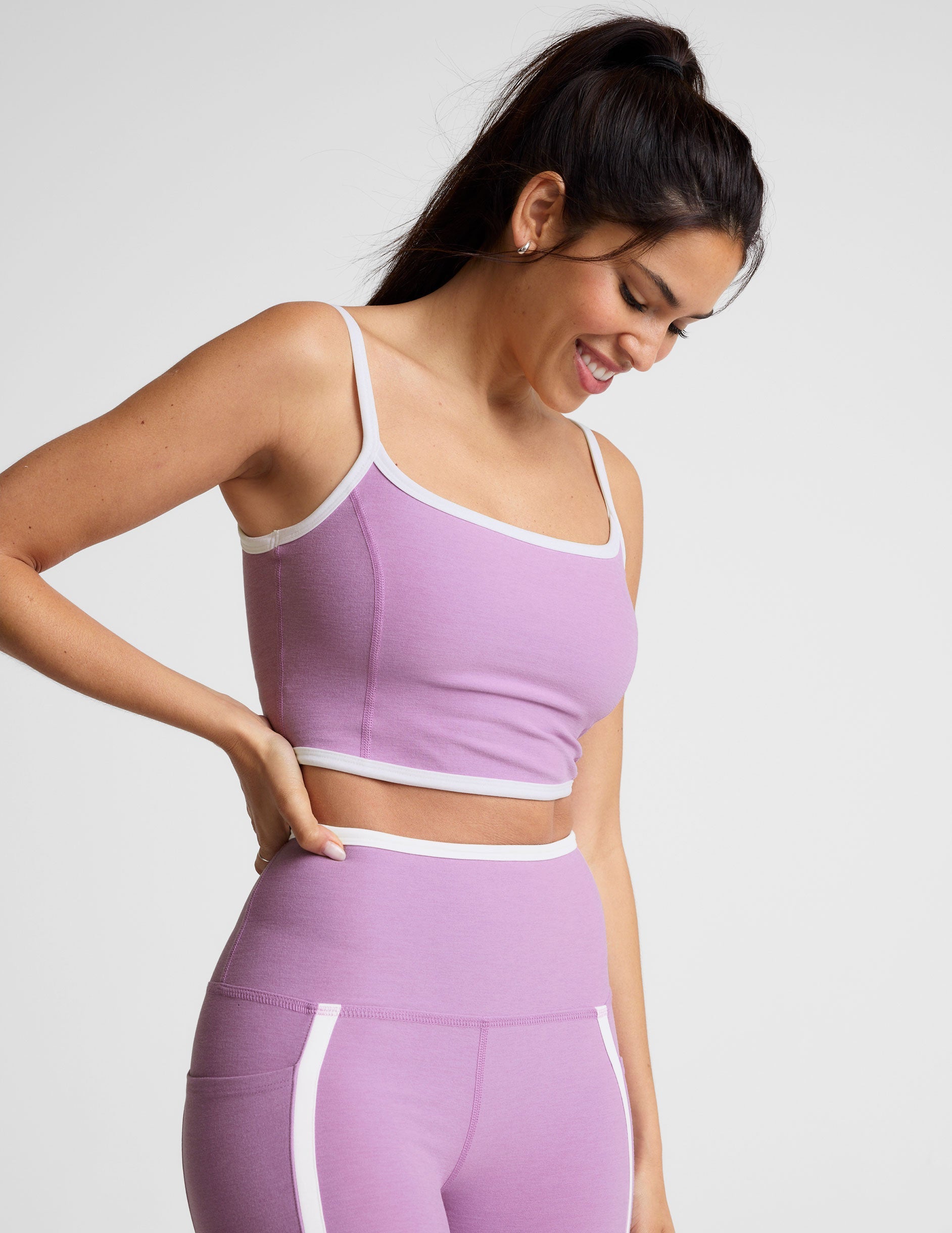 purple cropped tank with princess seams and white piping along edges.