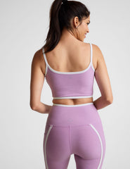 purple cropped tank with princess seams and white piping along edges.